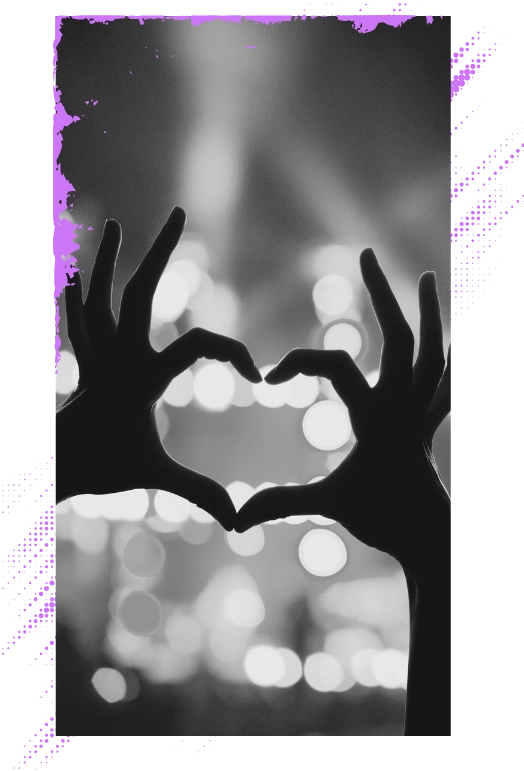 fan holding heart hands at concert having a fun time